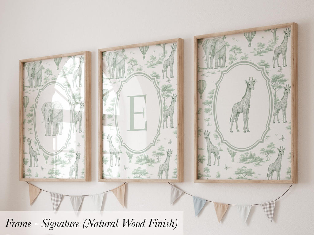three framed artworks with a giraffe and other wildlife motifs, displayed on a wall.