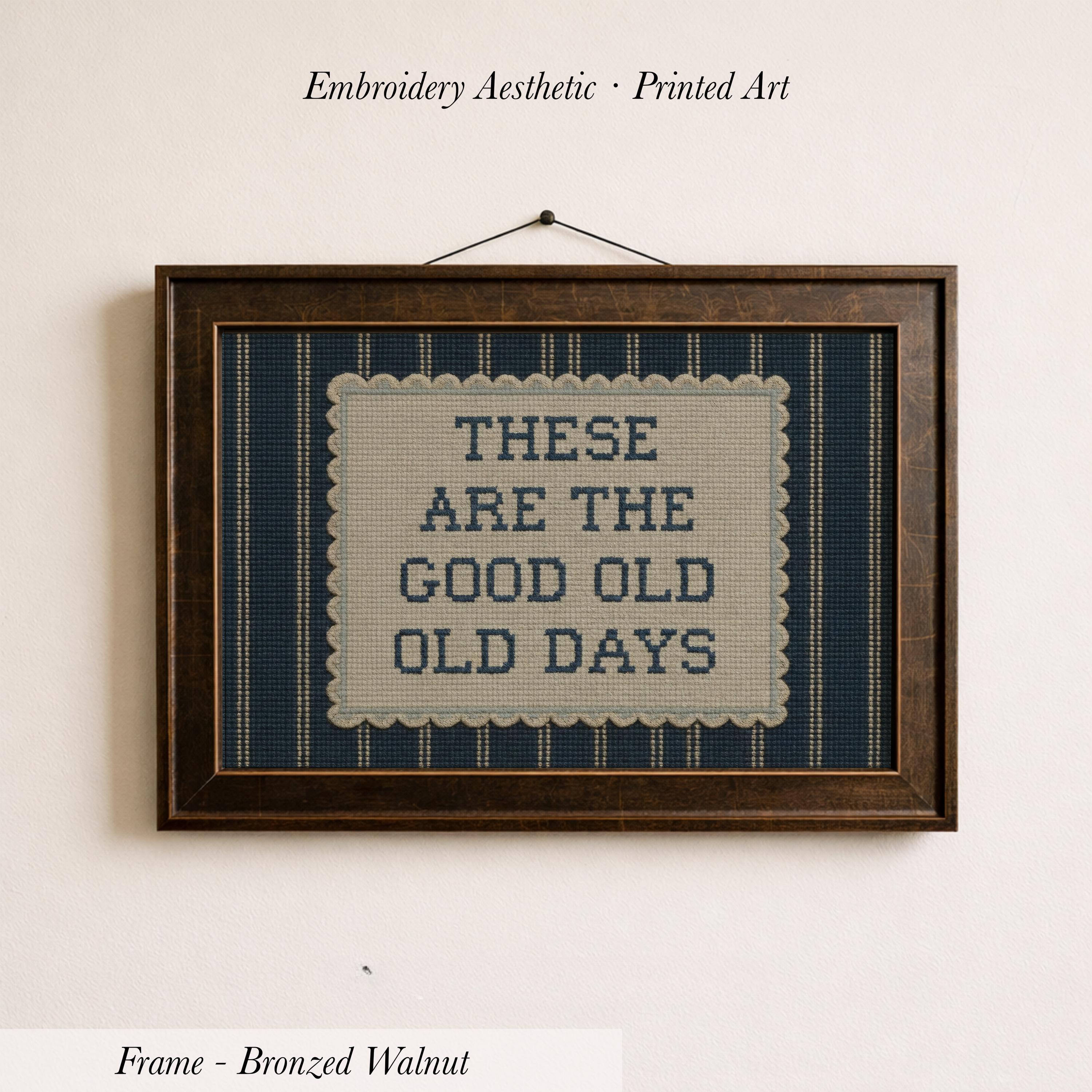 The image is a framed embroidered piece of art with the text "These are the good old days" printed on it.