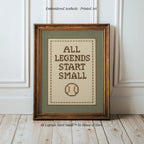 A framed cross-stitch design with the text "ALL LEGENDS START SMALL" and a baseball motif.