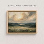 The image is a painting of a natural landscape, featuring a field with trees and mountains in the background. The painting is framed in a natural wood floating frame, which complements the overall aesthetic of the artwork.
