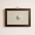 a framed picture of a cowboy riding a horse, with a small piece of paper with a drawing of a cowboy and a horse in the center of the frame.