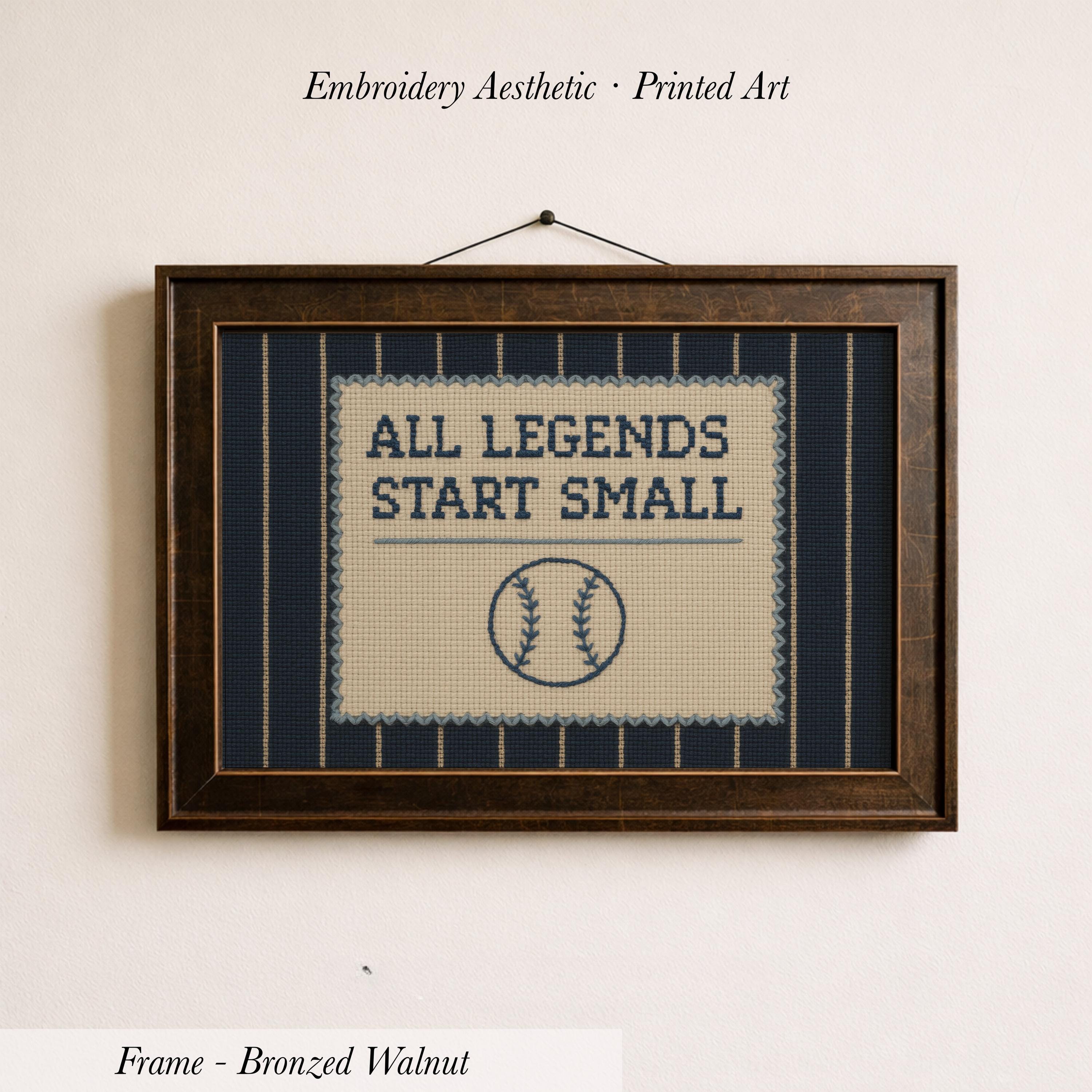 a framed embroidered design with the text "ALL LEGENDS START SMALL" and a baseball graphic.