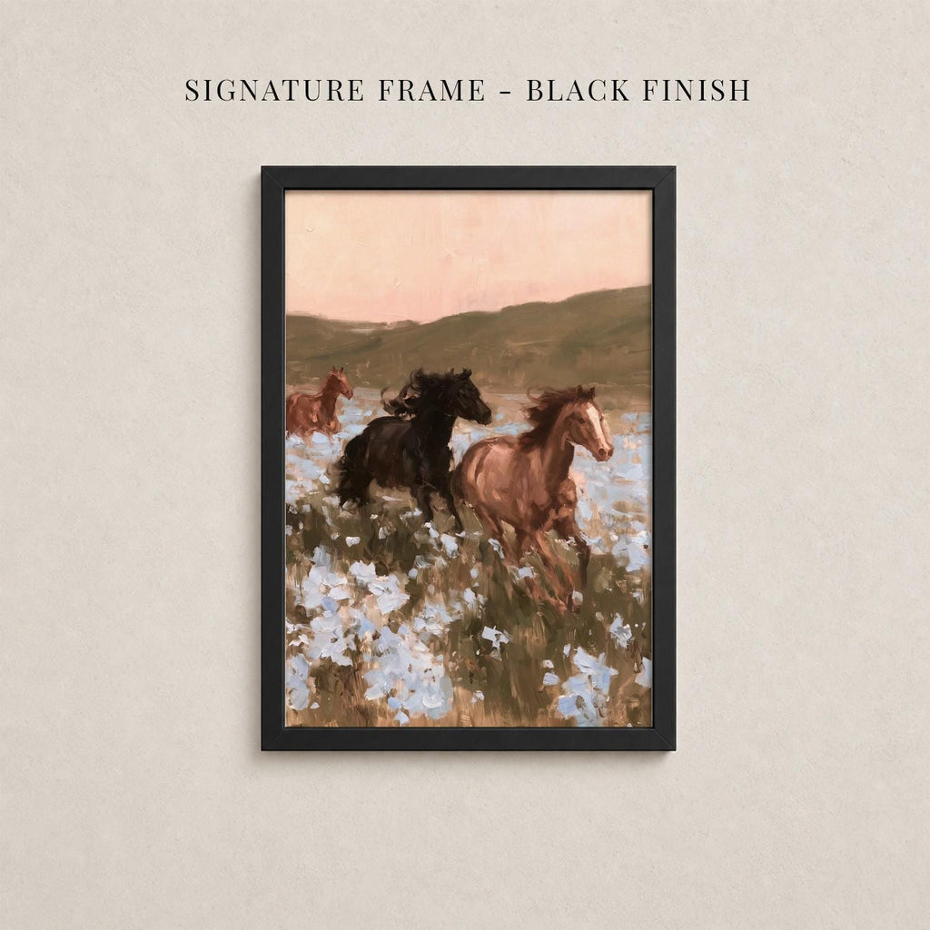 The image is a framed painting depicting three horses galloping through a field of flowers.