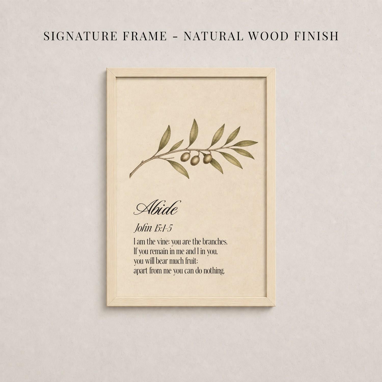 a framed print with a natural wood finish, displaying a branch with leaves and two small fruits. The text within the frame provides a definition or explanation of the word "Alike".