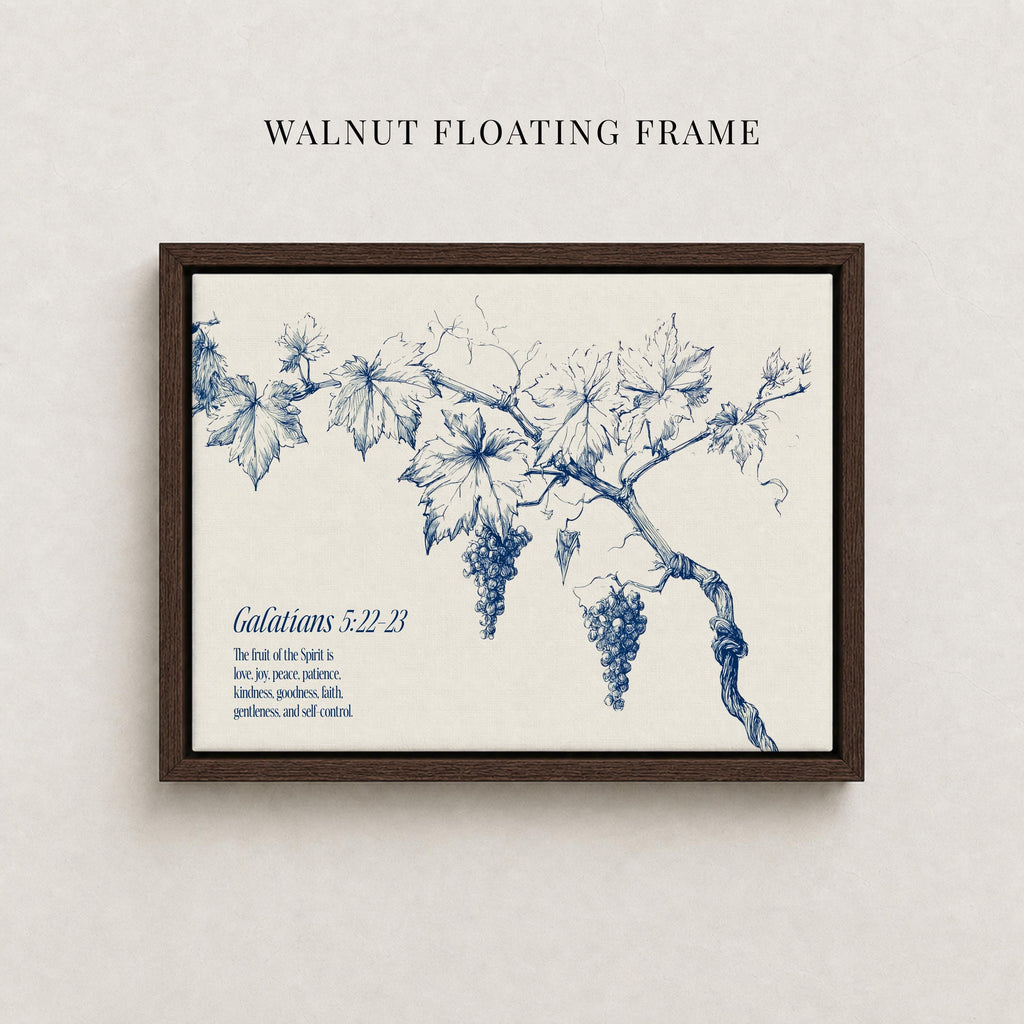 The image is a framed print featuring a detailed illustration of a grape vine with grapes hanging from it. The text below the illustration provides a biblical reference, specifically Galatians 5:22-23, which translates to "The joy of the spirit is love, patience, kindness, good-heartedness, gentleness, and self-control."