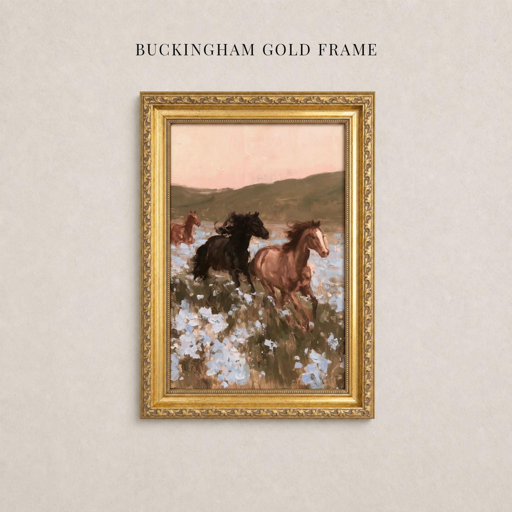 A painting of three horses running through a field of flowers, framed in a gold frame.