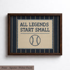 a framed cross-stitch design with the text "ALL LEGENDS START SMALL" and a baseball motif.