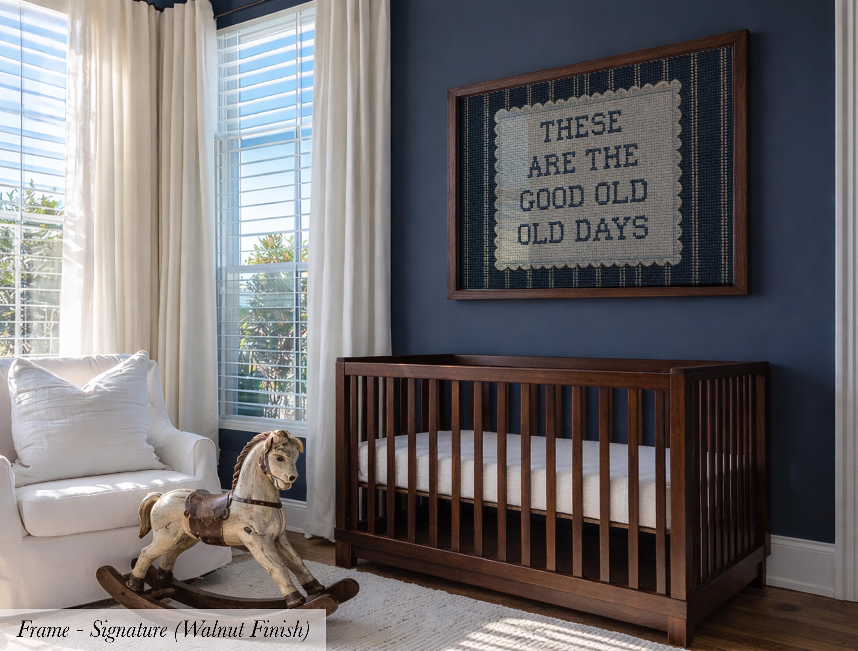 A nursery room with a wooden crib, a rocking horse, and a framed sign on the wall that reads "These are the good old days".