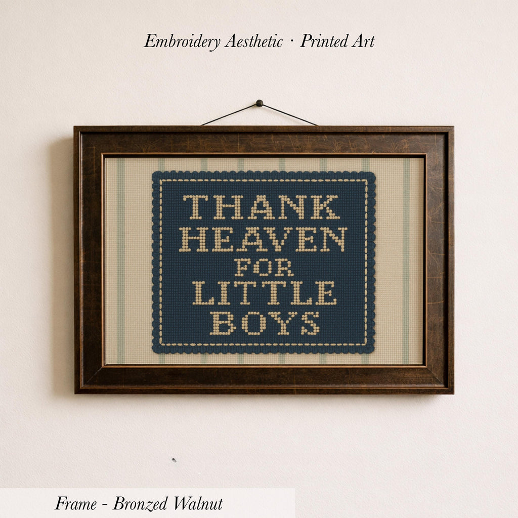 a framed embroidered piece of art with the text "THANK HEAVEN FOR LITTLE BOYS" on it.