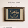 a framed embroidered piece of art with the text "THANK HEAVEN FOR LITTLE BOYS" on it.