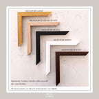 a collection of five signature frames in various colors and materials, including gold, natural wood, black, white, and walnut. The frames are arranged in a row, with the gold frame being the largest and the walnut frame being the smallest. The image also includes a caption that states all measurements are taken by hand and may vary slightly.