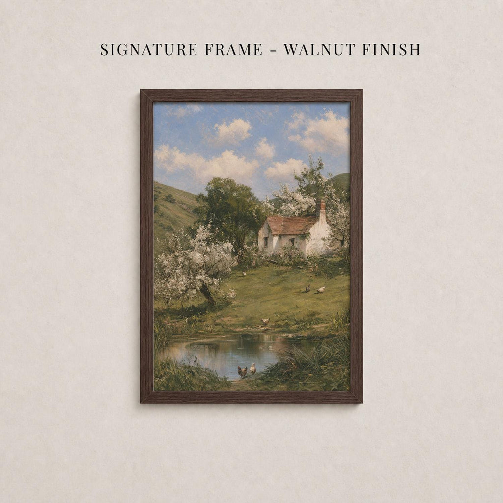 The image is a framed painting depicting a rural landscape with a small white house, a pond, and trees with white flowers.