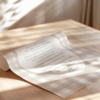 a rolled-up paper with text on it, resting on a wooden surface.