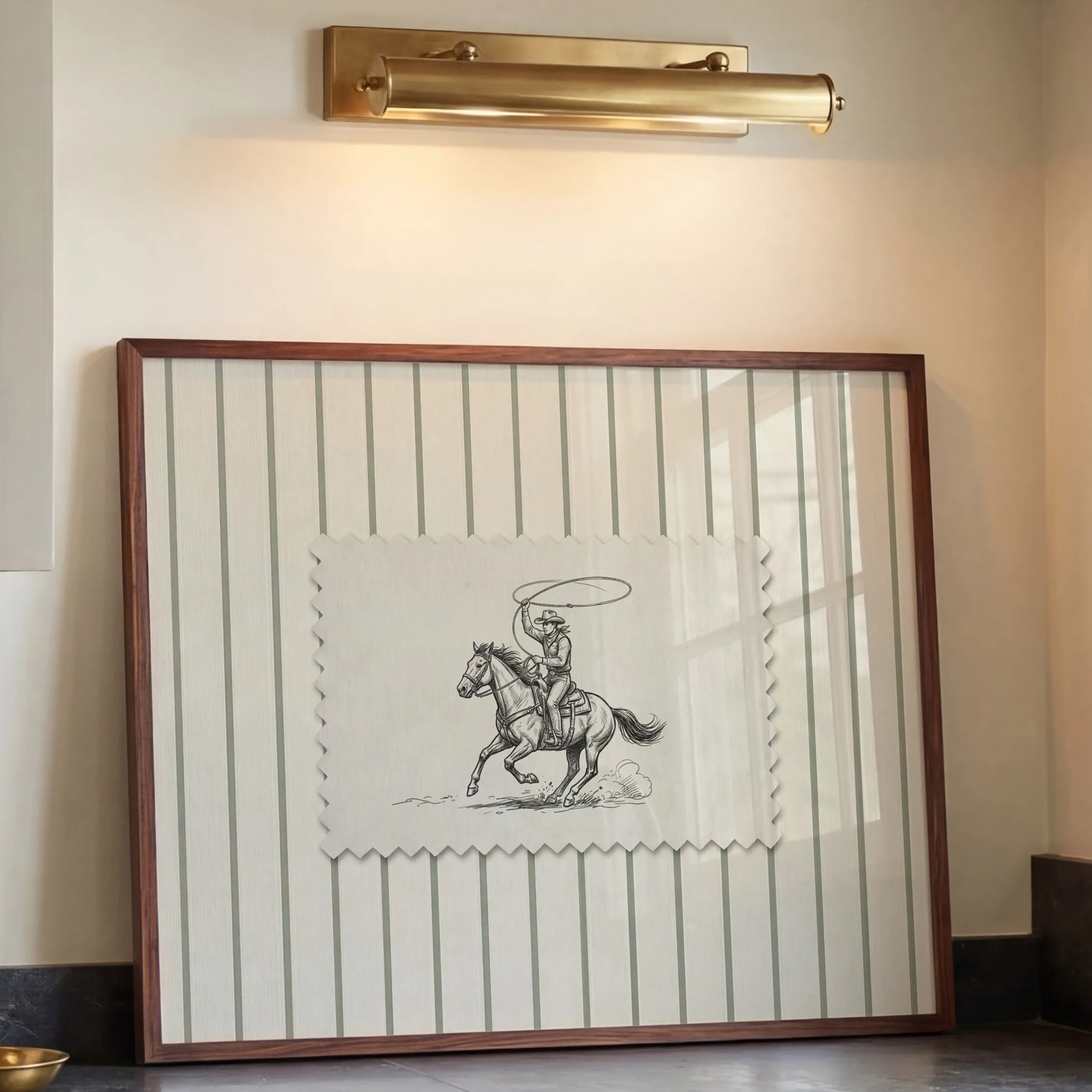 a kitchen with a framed picture of a cowboy on the wall above a sink. The kitchen has white cabinets and a marble countertop.