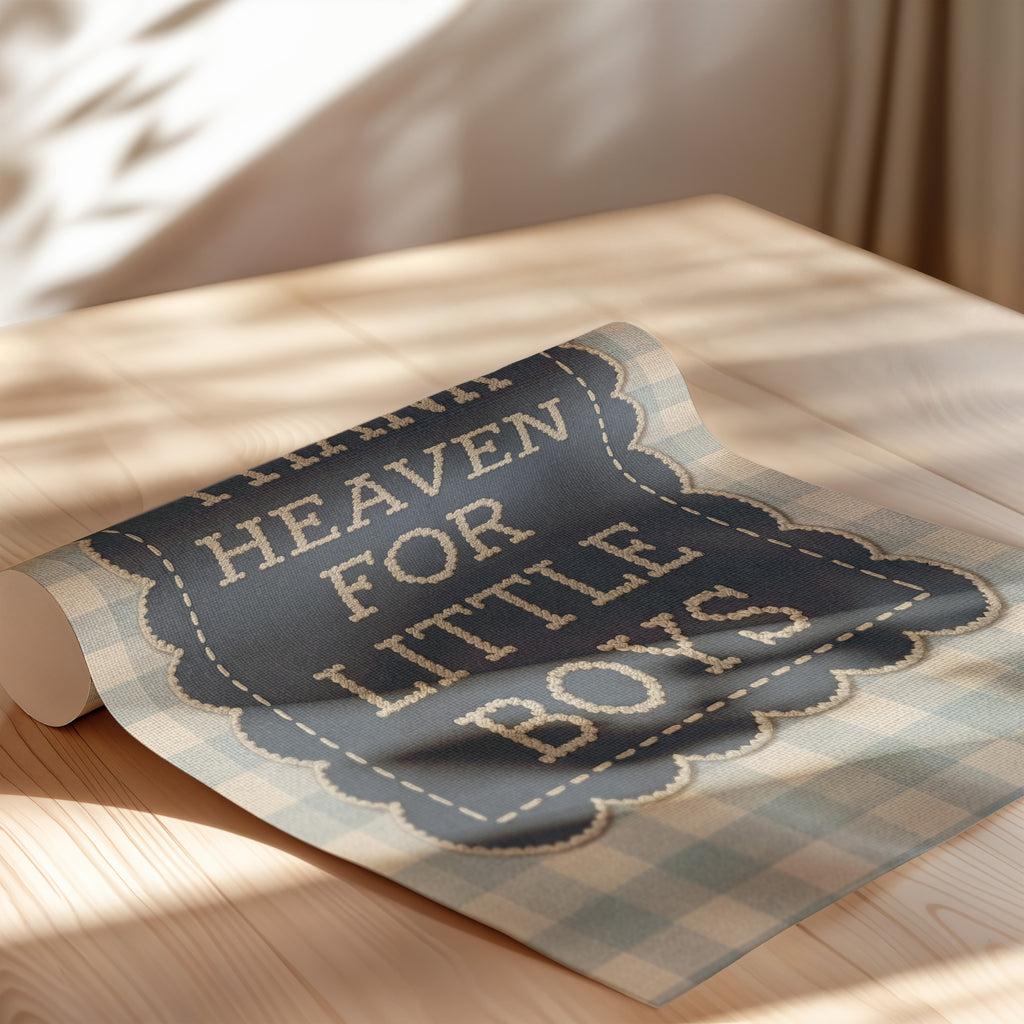a blue and white plaid fabric with the text "HEAVEN FOR LITTLE BOYS" printed on it, placed on a wooden surface.