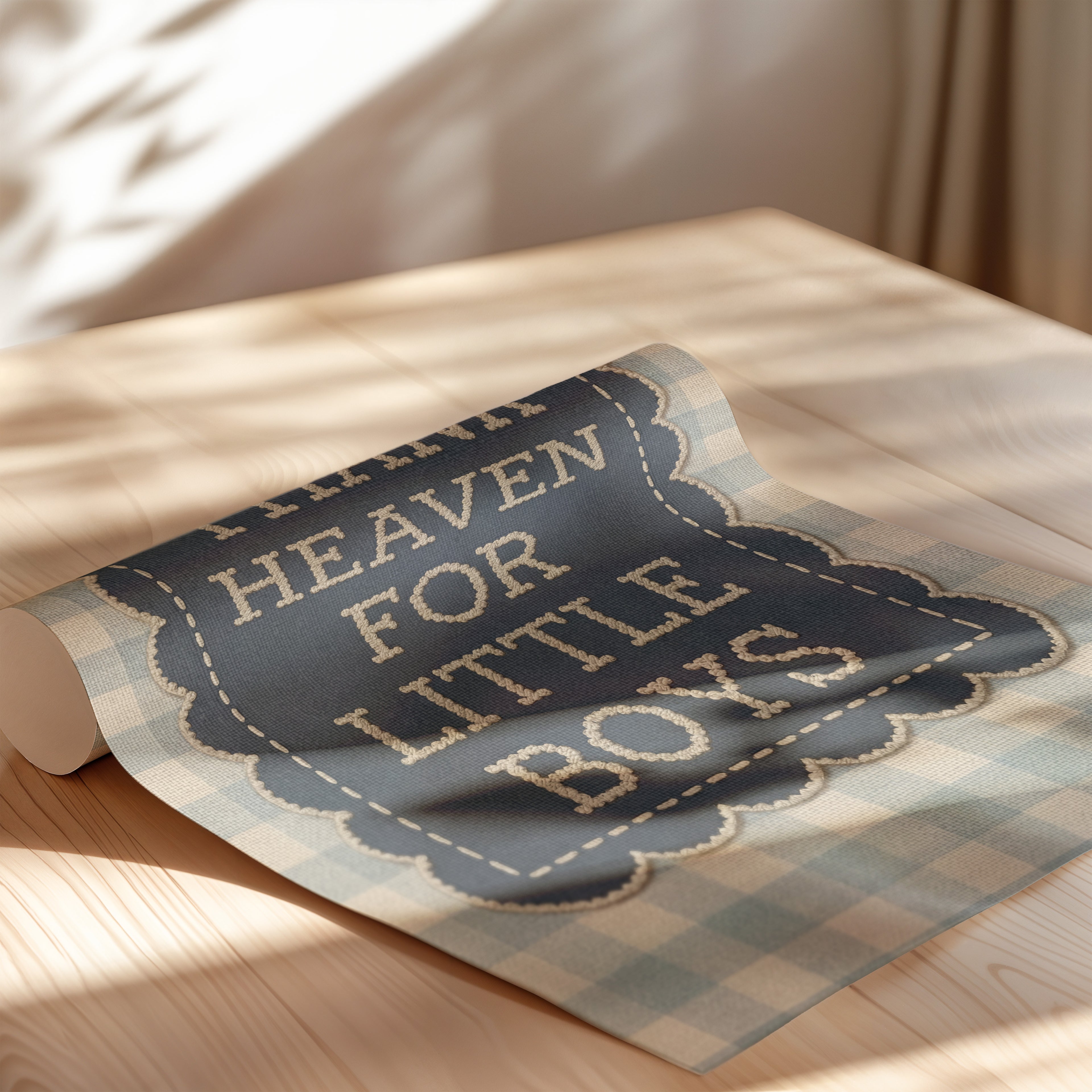 a blue and white plaid fabric with the text "HEAVEN FOR LITTLE BOYS" printed on it, placed on a wooden surface.
