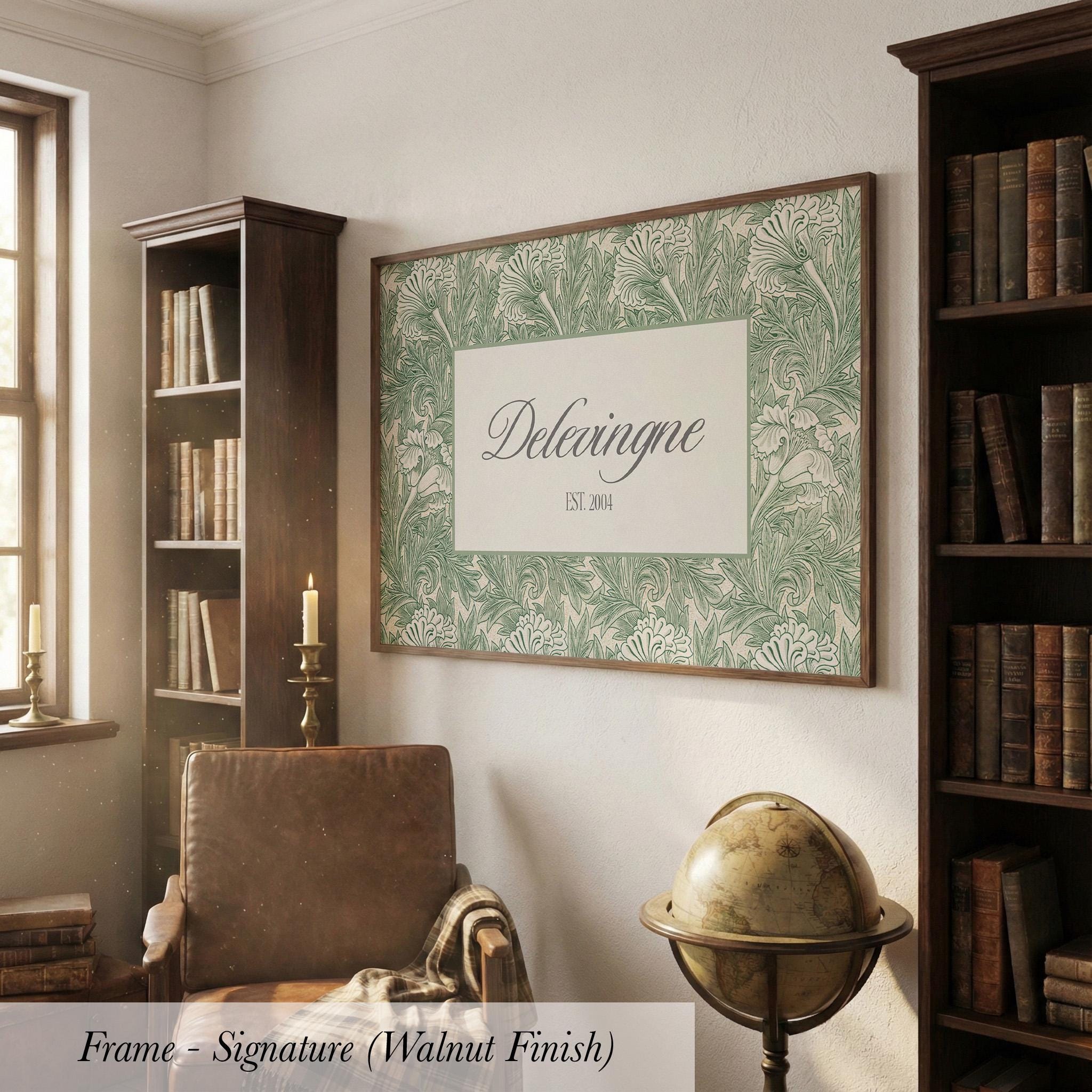 a cozy living room with a large framed poster of Delvinge Est. 2014 hanging on the wall, surrounded by bookshelves filled with books and a globe on a stand.