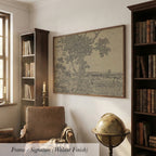 a cozy living room with a large framed artwork depicting a tree on the wall, a leather armchair, a globe, and a bookshelf filled with books.