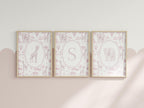 three framed pictures of giraffes and elephants, each with a unique design and color scheme.