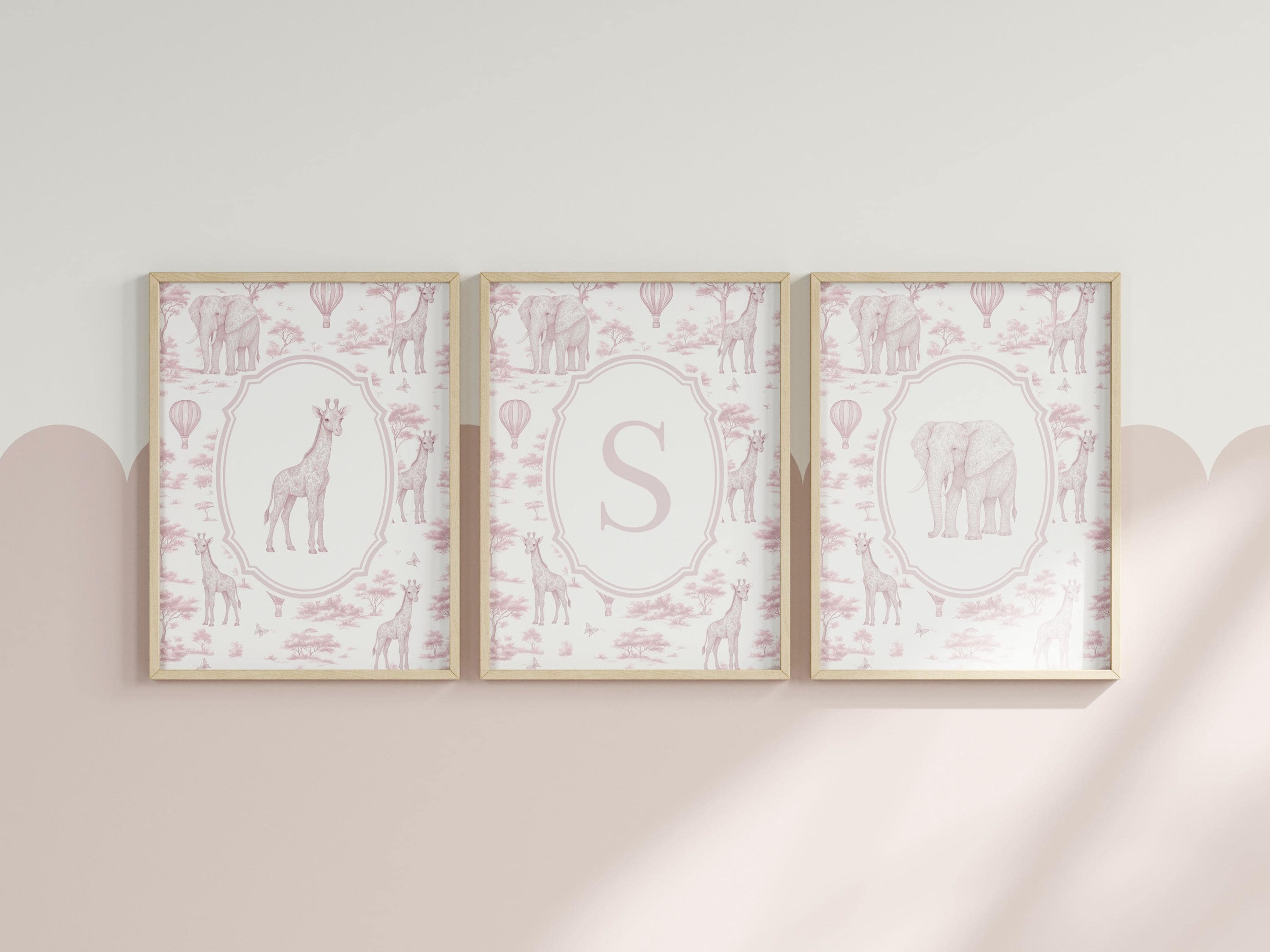 three framed pictures of giraffes and elephants, each with a unique design and color scheme.