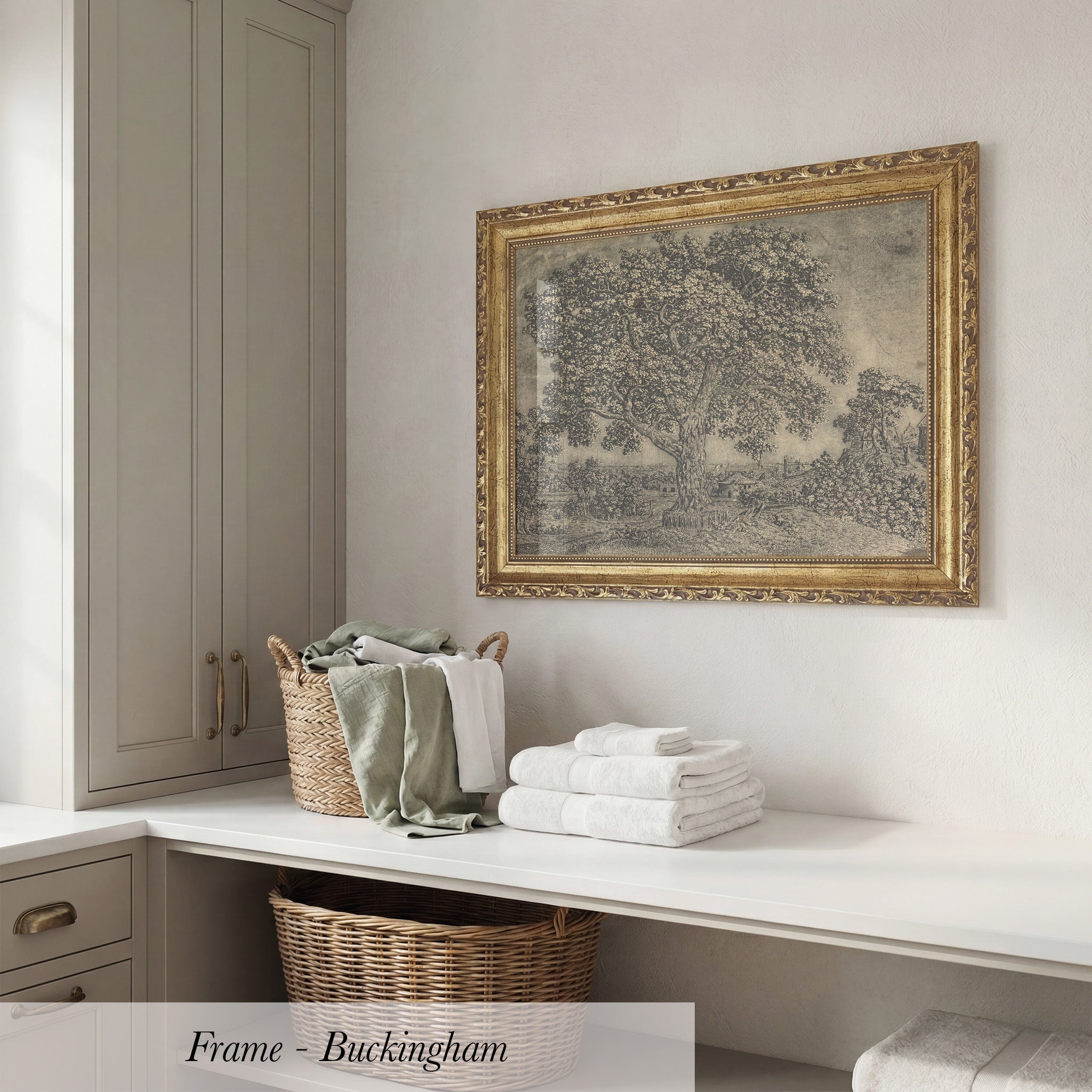 a white shelf with a wicker basket and a stack of folded towels, along with a framed picture of a tree hanging on the wall above the shelf.