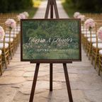 a wedding ceremony setup with a wooden sign displaying the names 'Sierra & Hunter' and the date 'SEPTEMBER 19, 2026'. The sign is placed in front of rows of chairs, and there are pink flowers decorating the chairs. The setting appears to be a garden or outdoor venue, with string lights visible in the background.