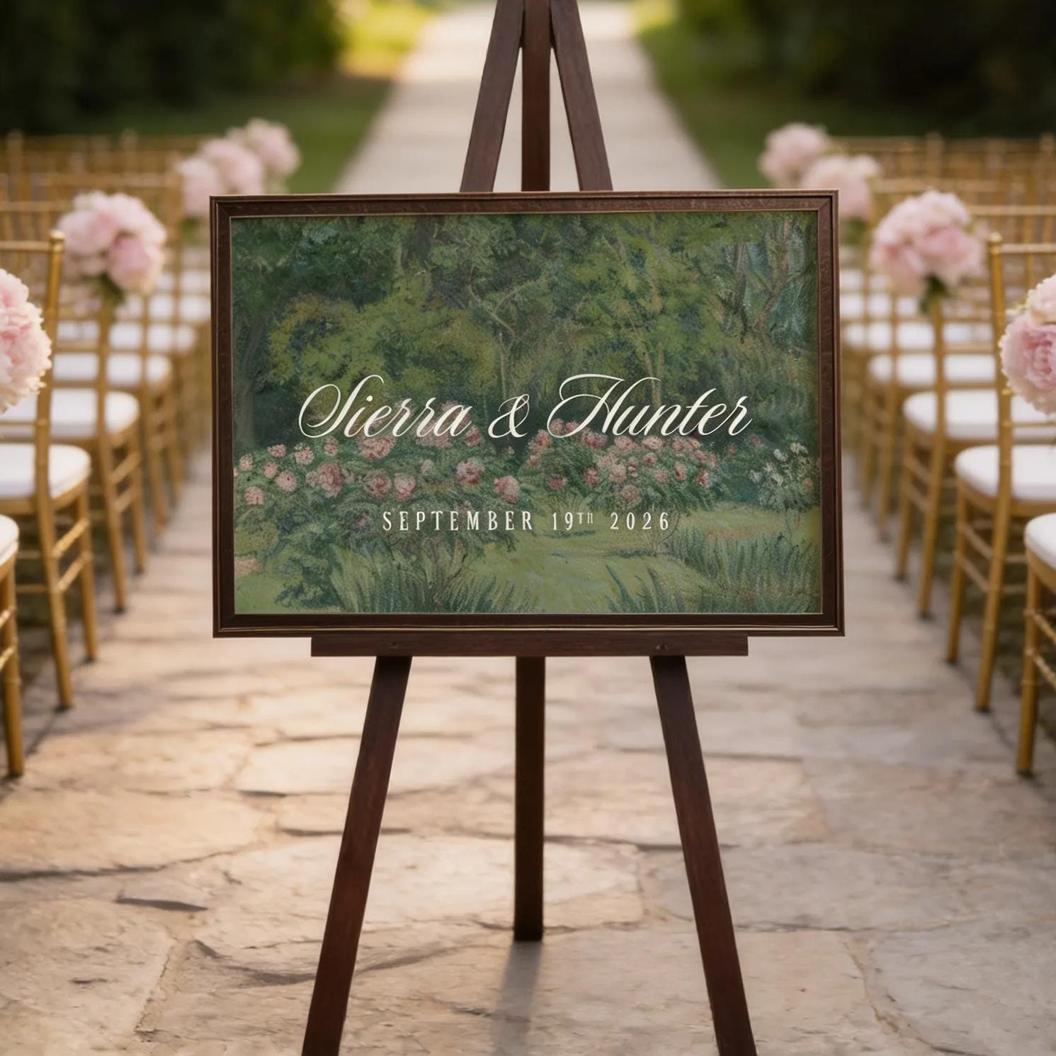a wedding ceremony setup with a wooden sign displaying the names 'Sierra & Hunter' and the date 'SEPTEMBER 19, 2026'. The sign is placed in front of rows of chairs, and there are pink flowers decorating the chairs. The setting appears to be a garden or outdoor venue, with string lights visible in the background.
