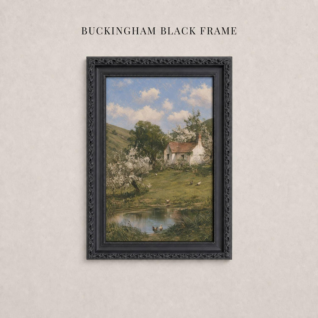 A framed painting depicting a rural landscape with a pond, trees, and a house in the background.