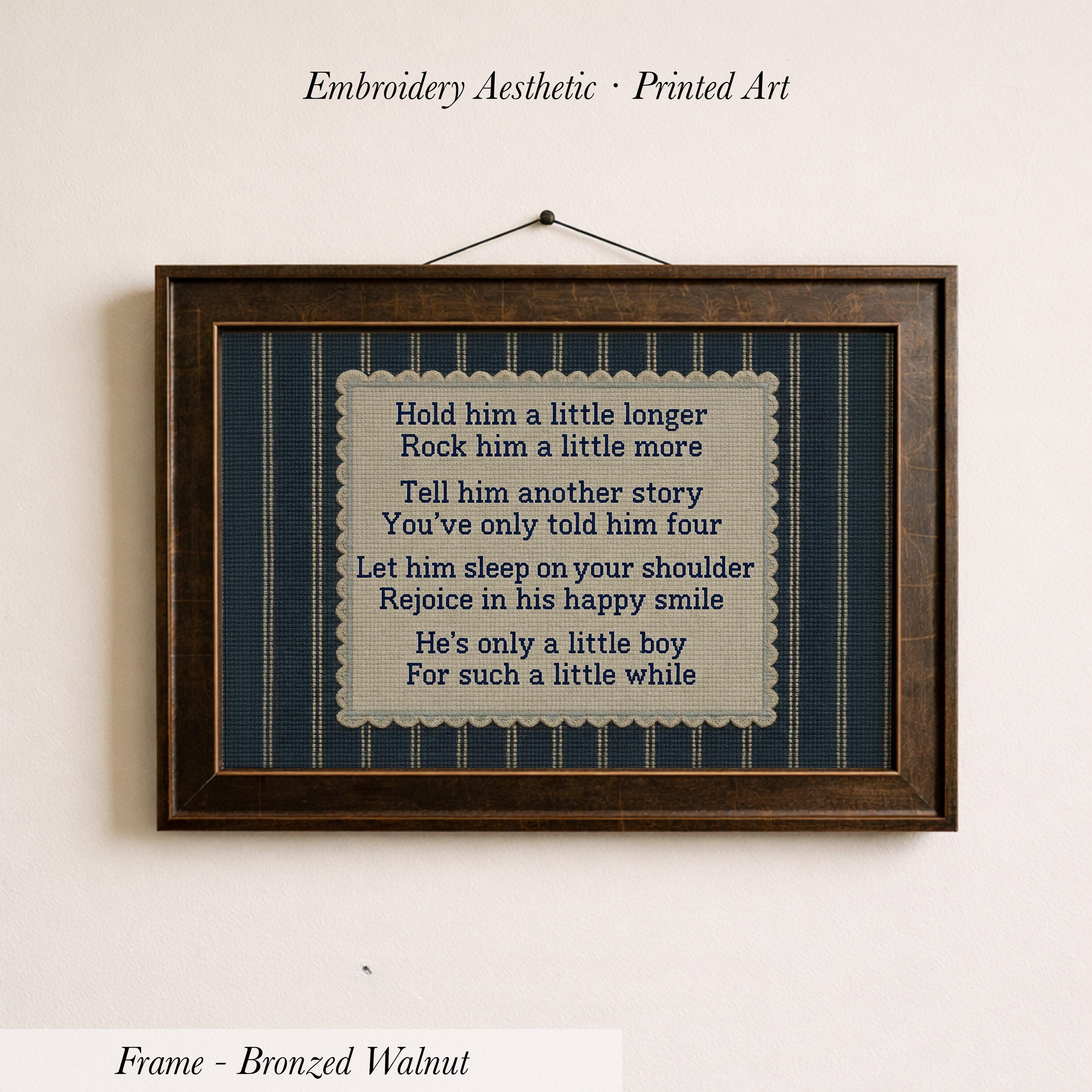 a framed piece of embroidered art with a printed poem on it, hanging on a wall.