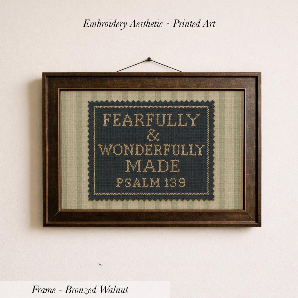 a framed cross-stitch design with the text "FEARFULLY & WONDERFULLY MADE PSALM 139" printed on it.