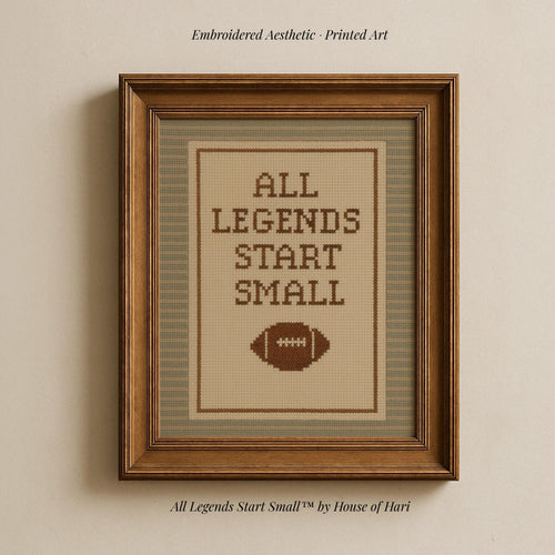 a framed embroidered cross-stitch design with the text "ALL LEGENDS START SMALL" and a football motif.