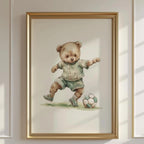 A framed illustration of a teddy bear wearing a green shirt and shorts, playing with a soccer ball.