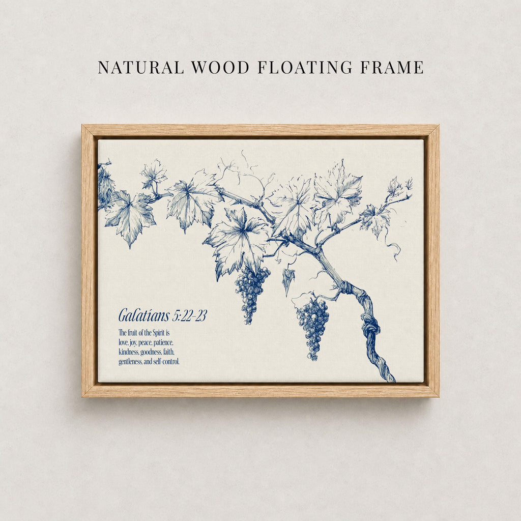 The image is a framed print featuring a blue and white illustration of a branch with grapes hanging from it. The text below the illustration reads "Galatians 5:22-23" and provides a biblical verse from the book of Galatians.