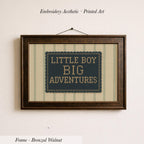 a framed embroidered design with the text "LITTLE BOY BIG ADVENTURES" on it.