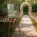 A beautifully decorated outdoor wedding ceremony setup, with a wooden aisle lined with chairs leading to a floral archway at the end. The chairs are neatly arranged, and the archway is adorned with white flowers, creating a romantic and elegant atmosphere.