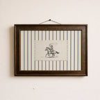 a framed picture of a cowboy riding a horse, with a black and white illustration of the cowboy and the horse.