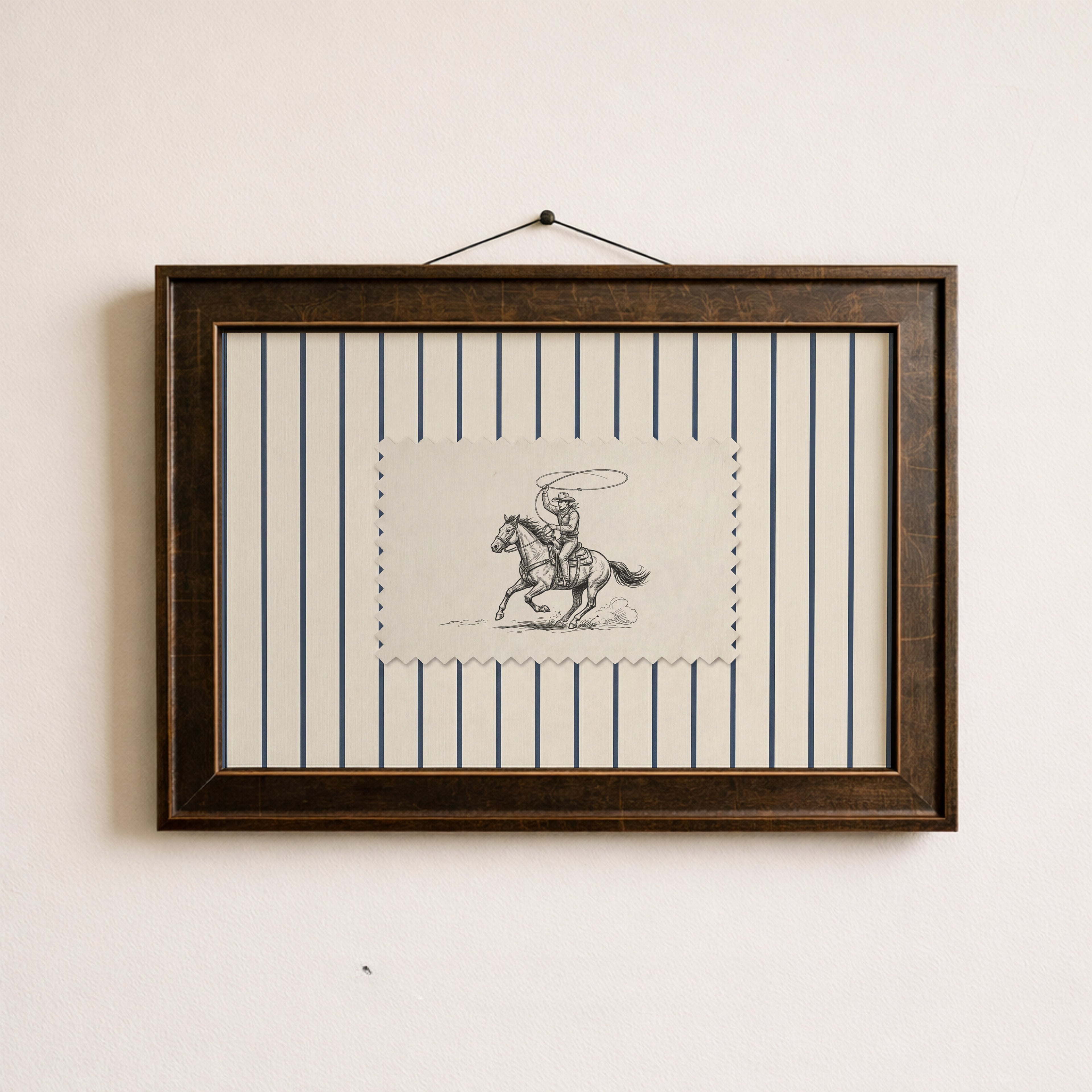a framed picture of a cowboy riding a horse, with a black and white illustration of the cowboy and the horse.