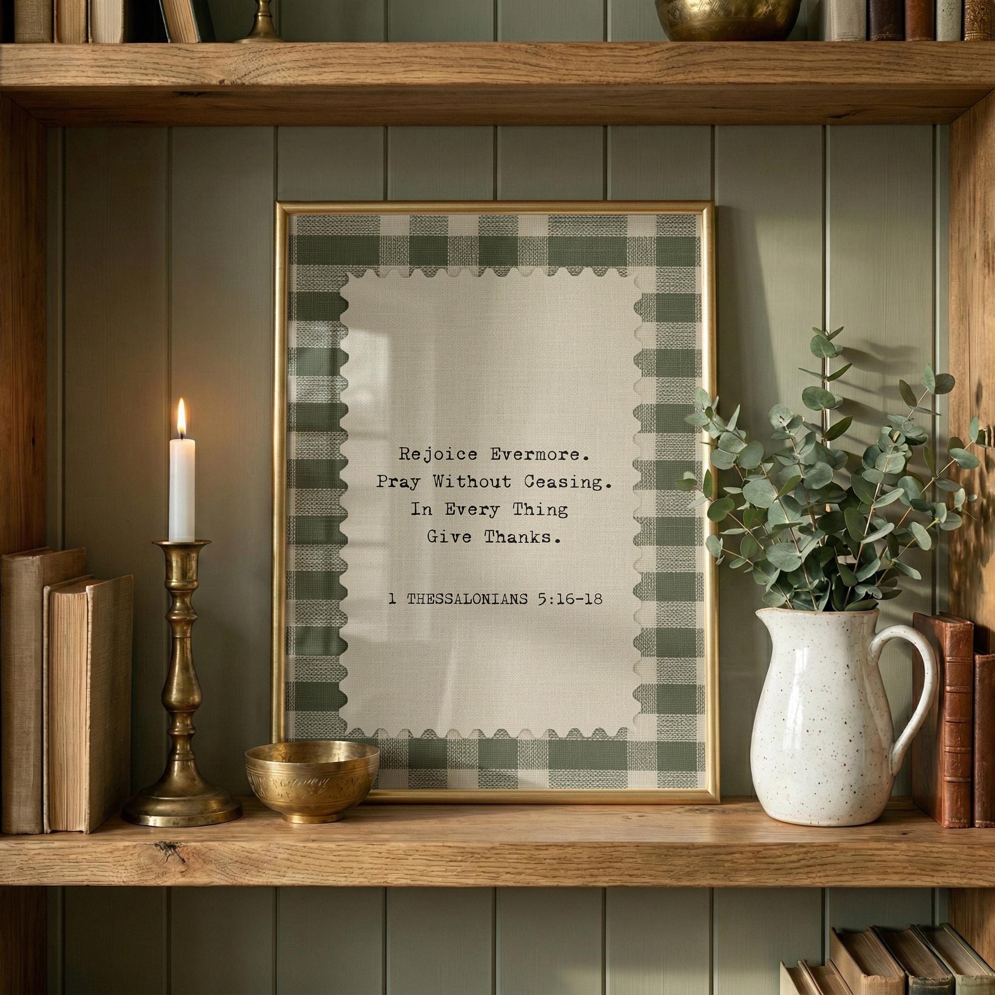 a framed quote on a wooden shelf, surrounded by various objects such as a candle, a vase with greenery, and books.