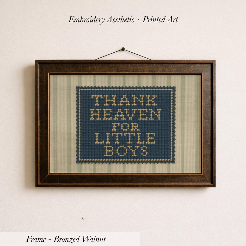 a framed embroidered piece of art with the text "THANK HEAVEN FOR LITTLE BOYS" on it.