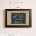 a framed embroidered piece of art with the text "THANK HEAVEN FOR LITTLE BOYS" on it.