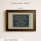 a framed embroidered piece of art with the text "THANK HEAVEN FOR LITTLE BOYS" on it.