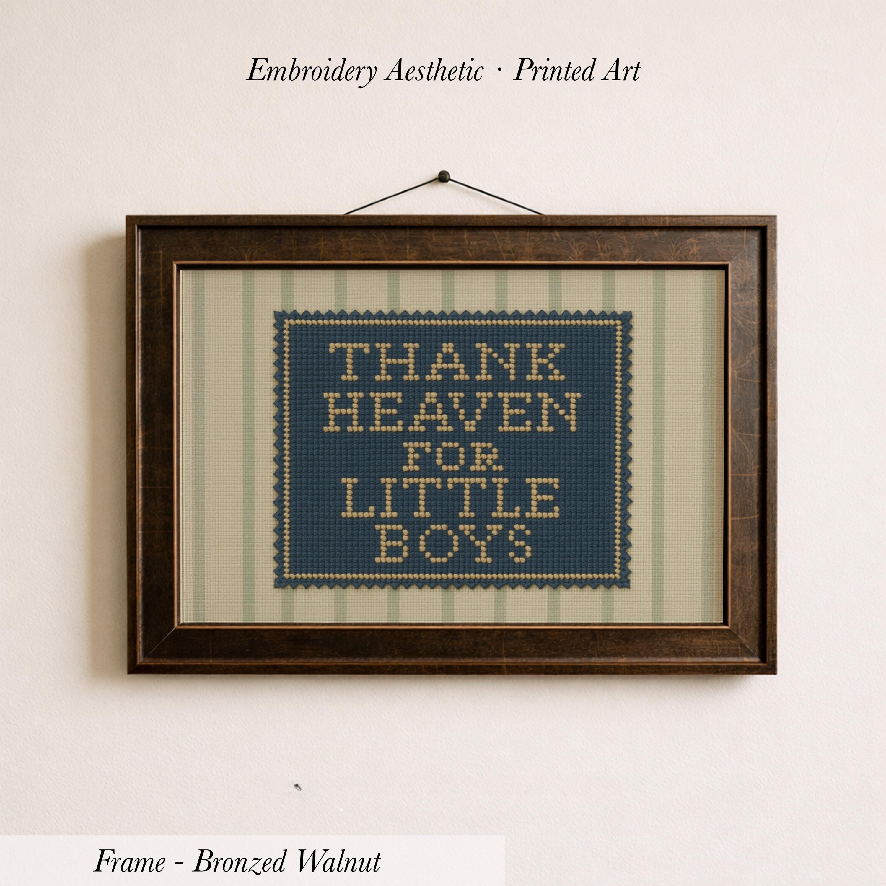 a framed embroidered piece of art with the text "THANK HEAVEN FOR LITTLE BOYS" on it.