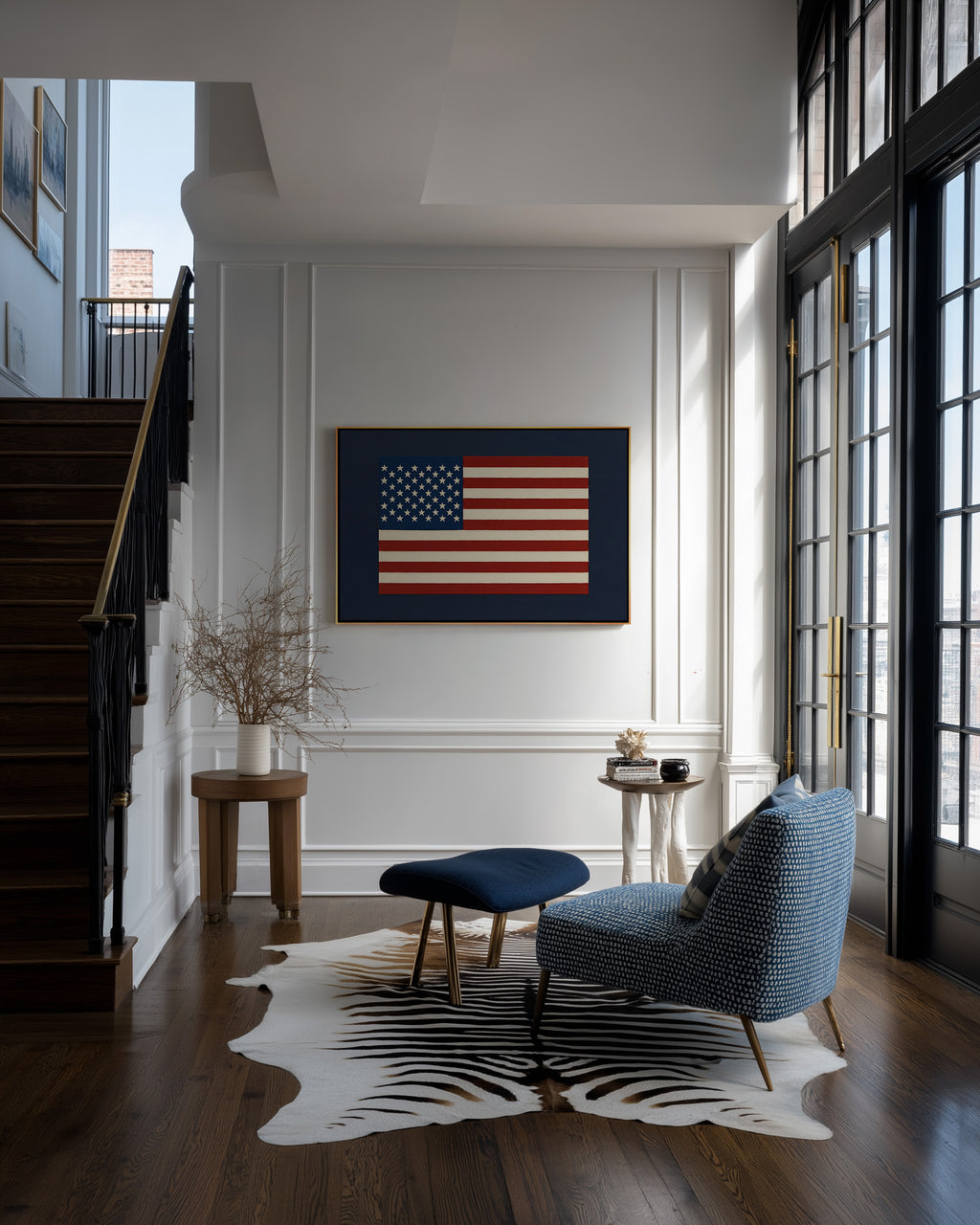 a modern living room with a large American flag artwork on the wall, a blue armchair, a wooden side table, and a zebra print rug.