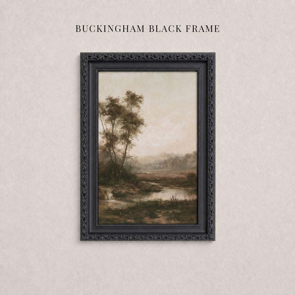 A framed landscape painting depicting a serene countryside scene with trees, a river, and a hazy sky.