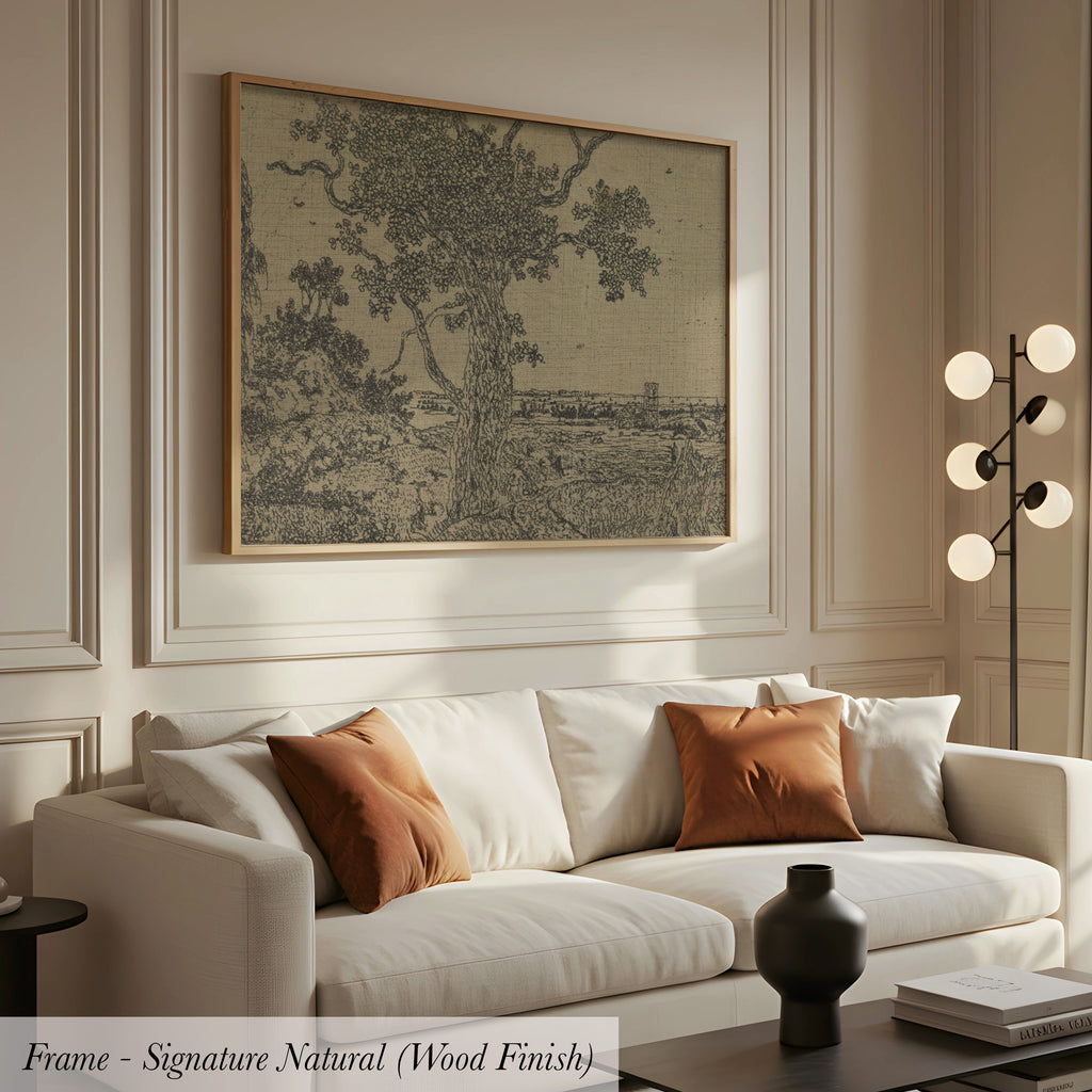 a living room with a white sofa, a framed artwork depicting a tree, and a lamp on a side table.