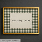 A framed image with a piece of paper inside, displaying the text "How Lucky Are We" against a background of a gingham pattern.
