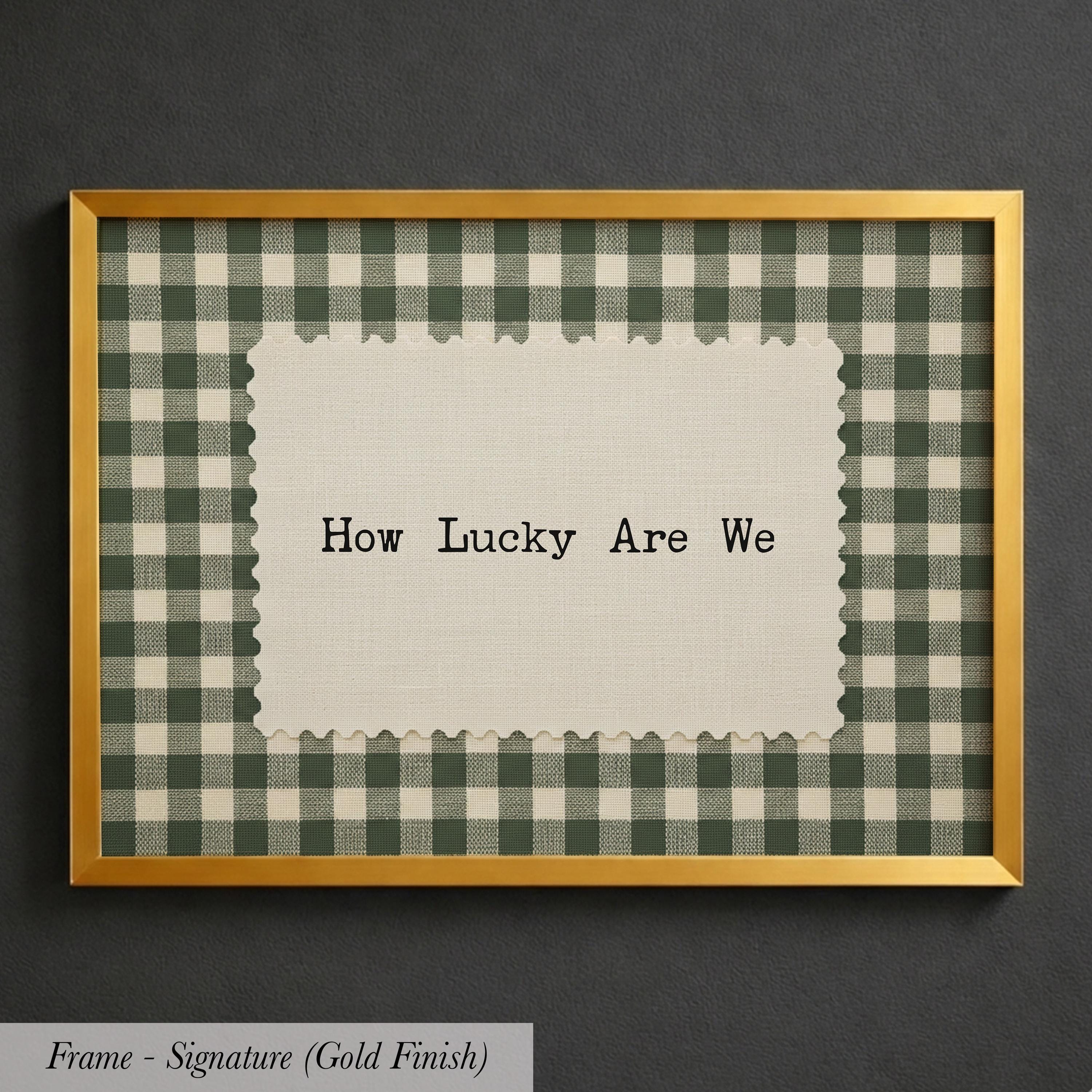 A framed image with a piece of paper inside, displaying the text "How Lucky Are We" against a background of a gingham pattern.