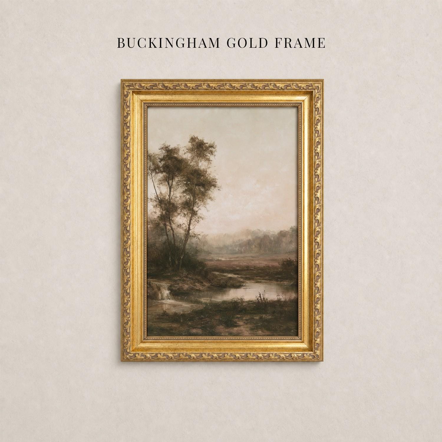 A framed landscape painting depicting a serene countryside scene with trees, a river, and a hazy sky.
