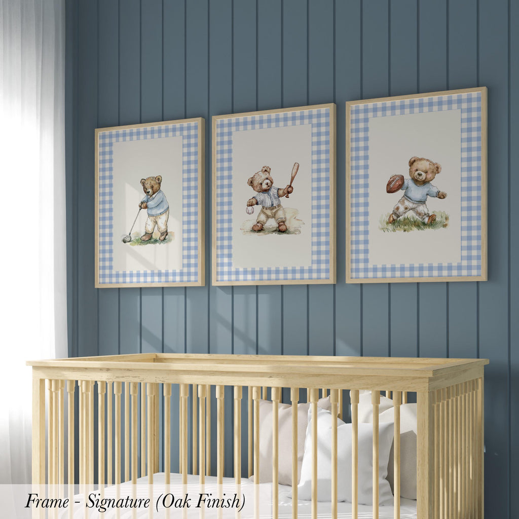 A nursery room with a wooden crib and three framed pictures of teddy bears on the wall.