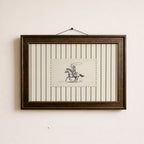 a framed artwork of a cowboy riding a horse, with a black and white illustration of the cowboy and the horse.